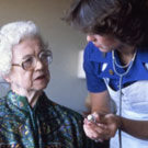 Nurse helping elderly woman